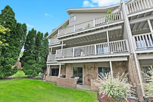 21112 Boulder Cir, Northville, MI 48167 - back of property with a balcony, brick siding, and a yard