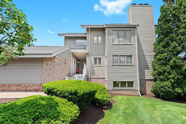 21112 Boulder Cir, Northville, MI 48167 - view of front of home featuring a chimney, brick siding, and a front lawn