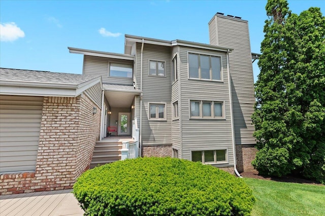 21112 Boulder Cir, Northville, MI 48167 - view of front of property featuring brick siding and a chimney