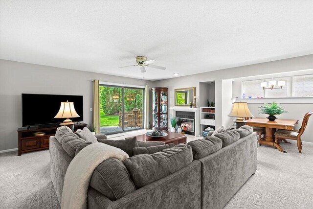 21112 Boulder Cir, Northville, MI 48167 - living area featuring light colored carpet, ceiling fan, and a chandelier