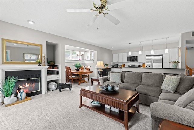 21112 Boulder Cir, Northville, MI 48167 - living area featuring light colored carpet, ceiling fan, and a glass covered fireplace