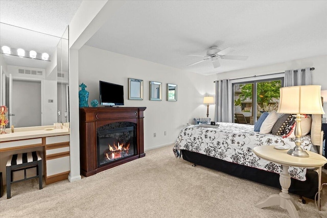 21112 Boulder Cir, Northville, MI 48167 - bedroom featuring carpet, a glass covered fireplace, and a ceiling fan