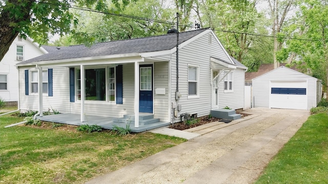 1418 Stamford Ave, Kalamazoo, MI 49048 - view of front of property featuring an outbuilding, covered porch, driveway, a garage, and roof with shingles