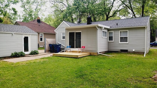 1418 Stamford Ave, Kalamazoo, MI 49048 - rear view of property featuring a deck, a lawn, a chimney, and a shingled roof