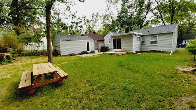 1418 Stamford Ave, Kalamazoo, MI 49048 - back of house with a wooden deck, a lawn, and an outbuilding