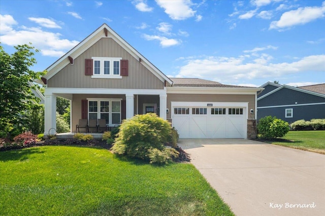 4441 Koinonia Dr NE Unit 3, Grand Rapids, MI 49525 - craftsman-style house featuring a porch, an attached garage, a front lawn, driveway, and board and batten siding