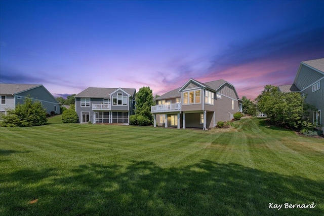 4441 Koinonia Dr NE Unit 3, Grand Rapids, MI 49525 - back of house at dusk with a yard, a sunroom, and a balcony