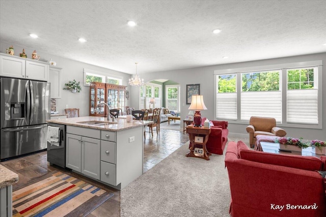 4441 Koinonia Dr NE Unit 3, Grand Rapids, MI 49525 - kitchen with stainless steel refrigerator with ice dispenser, dishwasher, a chandelier, plenty of natural light, and a textured ceiling