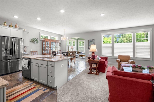 4441 Koinonia Dr NE Unit 3, Grand Rapids, MI 49525 - kitchen featuring stainless steel fridge, dishwasher, a chandelier, a textured ceiling, and open floor plan