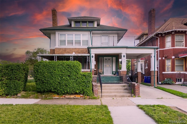 318 Chandler St, Detroit, MI 48202 - traditional style home featuring a porch, a balcony, brick siding, and a chimney