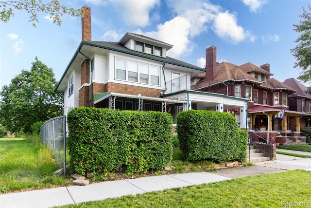 318 Chandler St, Detroit, MI 48202 - american foursquare style home with a chimney and a front yard