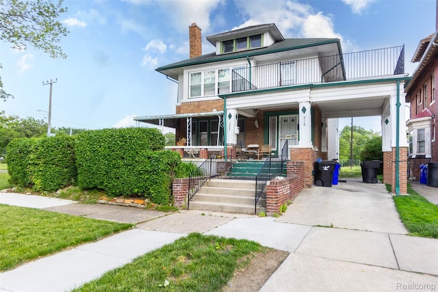 318 Chandler St, Detroit, MI 48202 - traditional style home with covered porch, a balcony, a chimney, brick siding, and concrete driveway