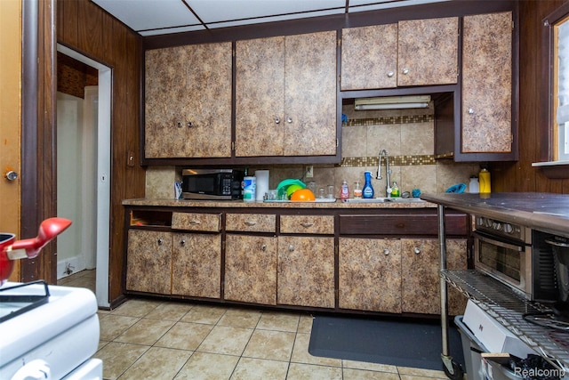 318 Chandler St, Detroit, MI 48202 - kitchen featuring light tile patterned floors and decorative backsplash