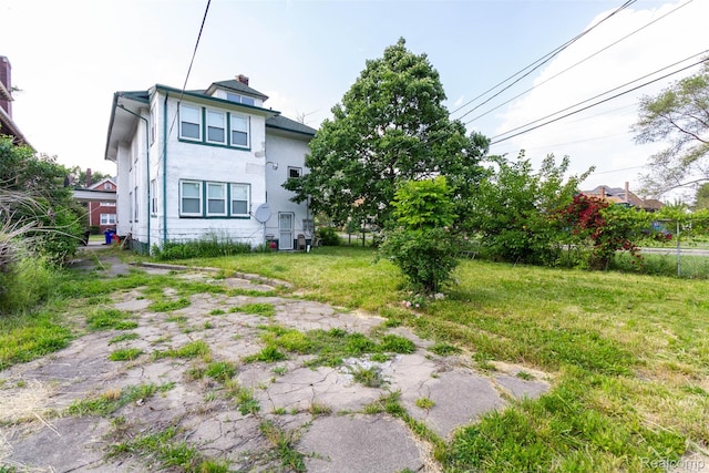 318 Chandler St, Detroit, MI 48202 - rear view of property with a chimney