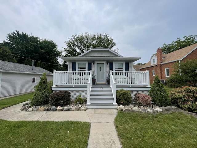 108 S Berrien St, New Buffalo, MI 49117 - view of front of house featuring covered porch and a front yard