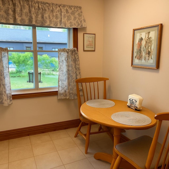 108 S Berrien St, New Buffalo, MI 49117 - dining area featuring light tile patterned floors and baseboards