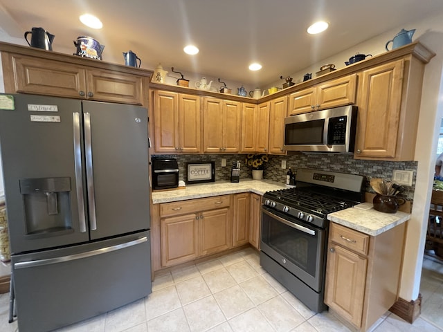 108 S Berrien St, New Buffalo, MI 49117 - kitchen featuring appliances with stainless steel finishes, light tile patterned flooring, tasteful backsplash, recessed lighting, and light stone counters