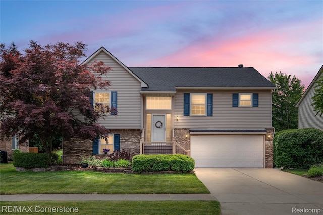 1232 Michael Dr, Westland, MI 48186 - split foyer home with concrete driveway, a garage, a front lawn, and brick siding