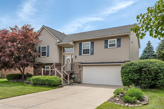 1232 Michael Dr, Westland, MI 48186 - raised ranch with a garage, driveway, a front yard, and brick siding