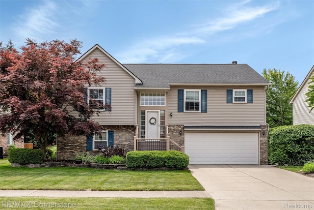 1232 Michael Dr, Westland, MI 48186 - split foyer home with concrete driveway, an attached garage, brick siding, and a front yard