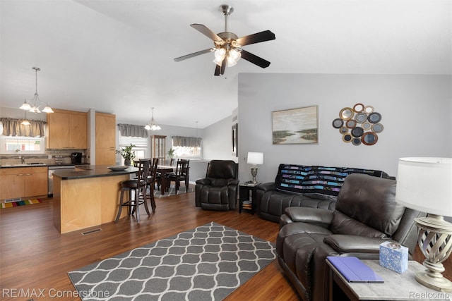 1232 Michael Dr, Westland, MI 48186 - living room featuring a chandelier, dark wood-style flooring, a ceiling fan, and lofted ceiling