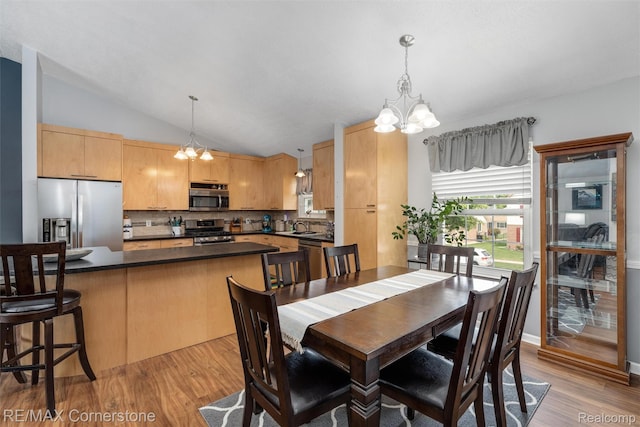 1232 Michael Dr, Westland, MI 48186 - dining room with a chandelier, light wood-style floors, and vaulted ceiling