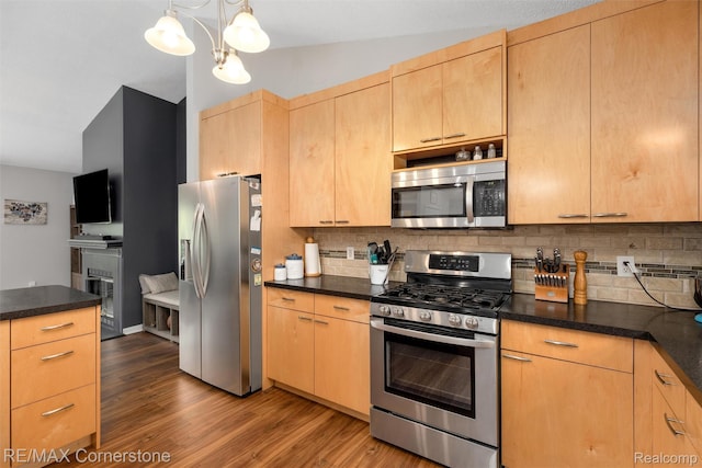 1232 Michael Dr, Westland, MI 48186 - kitchen featuring appliances with stainless steel finishes, light brown cabinetry, dark countertops, and backsplash