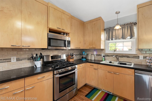 1232 Michael Dr, Westland, MI 48186 - kitchen featuring appliances with stainless steel finishes, light brown cabinets, decorative backsplash, and light wood-style floors