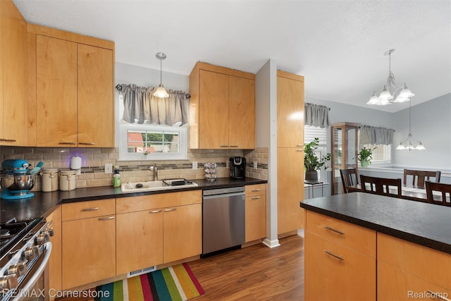 1232 Michael Dr, Westland, MI 48186 - kitchen with appliances with stainless steel finishes, a chandelier, dark countertops, and dark wood-style floors