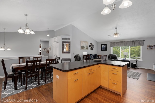 1232 Michael Dr, Westland, MI 48186 - kitchen featuring a chandelier, dark wood-style flooring, lofted ceiling, dark countertops, and a kitchen island