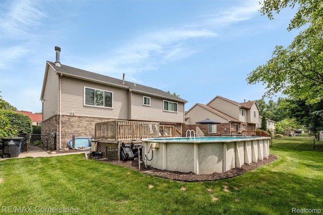 1232 Michael Dr, Westland, MI 48186 - back of house featuring an outdoor pool, brick siding, and a wooden deck