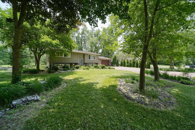 4787 Hooks Mill Rd, Adrian, MI 49221 - view of grassy yard with an attached garage and driveway