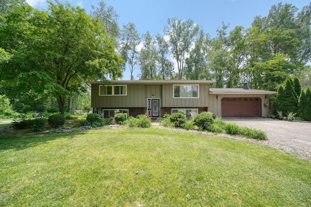 4787 Hooks Mill Rd, Adrian, MI 49221 - bi-level home with an attached garage, gravel driveway, and a front yard