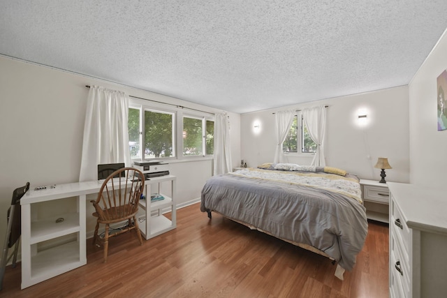4787 Hooks Mill Rd, Adrian, MI 49221 - bedroom featuring wood finished floors and a textured ceiling