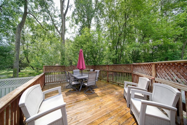 4787 Hooks Mill Rd, Adrian, MI 49221 - wooden deck with outdoor dining space and view of scattered trees