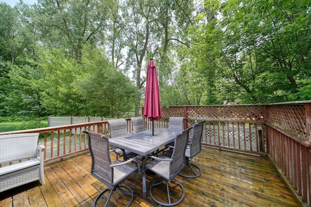 4787 Hooks Mill Rd, Adrian, MI 49221 - deck with outdoor dining space and view of scattered trees