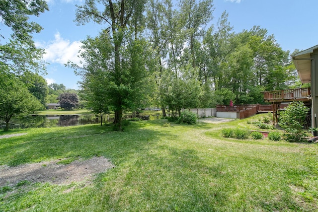 4787 Hooks Mill Rd, Adrian, MI 49221 - view of green lawn featuring a deck with water view and view of scattered trees