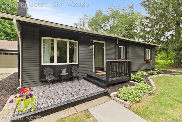 10129 Nimphie Rd, Fenton, MI 48430 - back of house with a chimney and a garage
