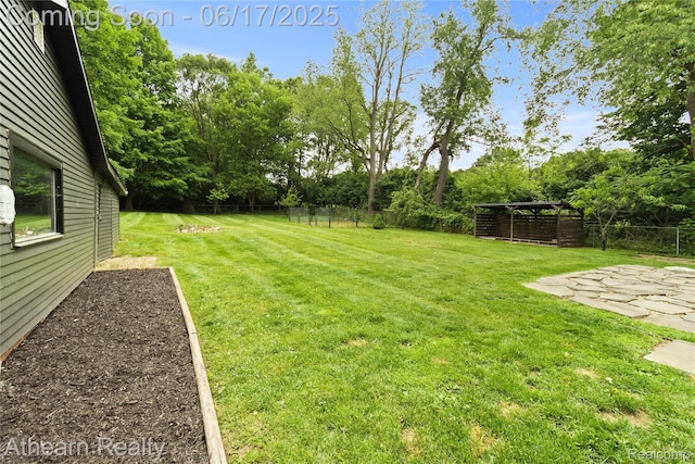 10129 Nimphie Rd, Fenton, MI 48430 - view of yard featuring view of wooded area and a patio area
