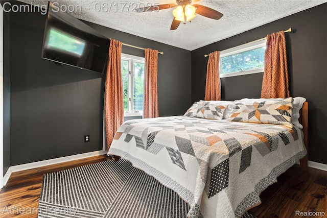 10129 Nimphie Rd, Fenton, MI 48430 - bedroom featuring wood finished floors, multiple windows, a textured ceiling, and ceiling fan