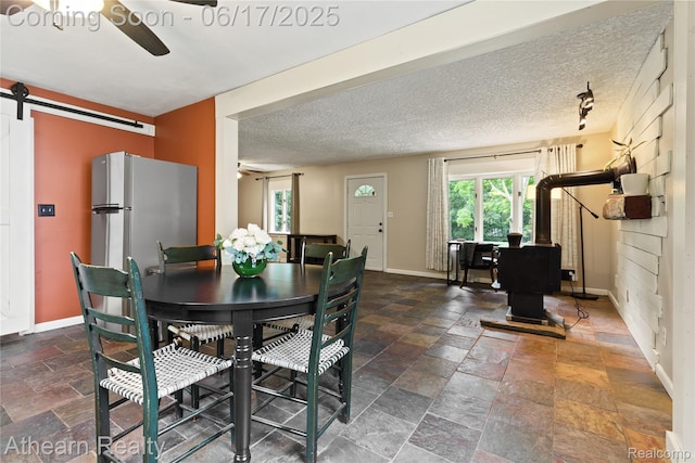 10129 Nimphie Rd, Fenton, MI 48430 - dining room featuring a ceiling fan and stone tile flooring