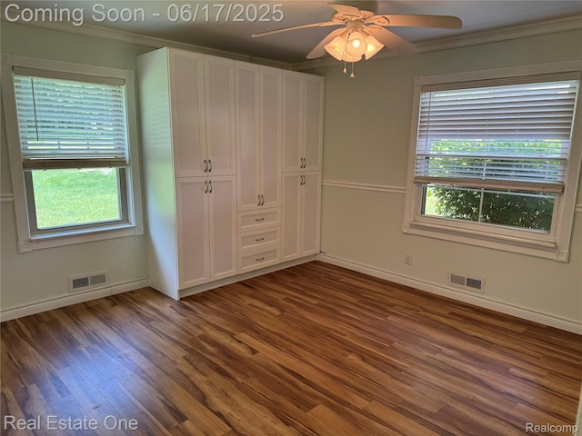 3340 Chickering Ln, Bloomfield Hills, MI 48302 - unfurnished bedroom featuring dark wood-style flooring, ornamental molding, multiple windows, a closet, and a ceiling fan