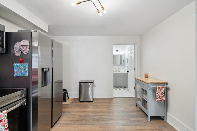 217 S Marshall Ave, Marshall, MI 49068 - kitchen featuring wood finished floors and stainless steel range with electric stovetop
