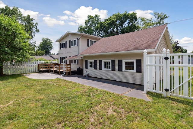 217 S Marshall Ave, Marshall, MI 49068 - back of house with a shingled roof, a wooden deck, and a patio area