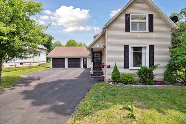 217 S Marshall Ave, Marshall, MI 49068 - view of front of house featuring a garage, driveway, and a chimney