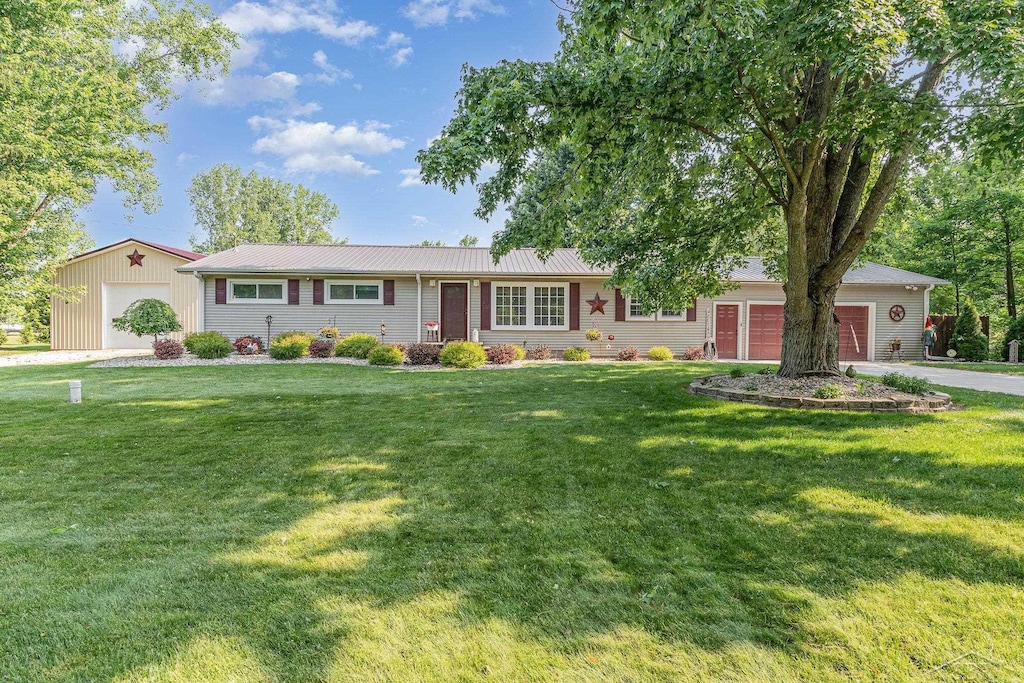 17278 Roosevelt Rd, Hemlock, MI 48626 - ranch-style house with a front yard, a metal roof, and an attached garage