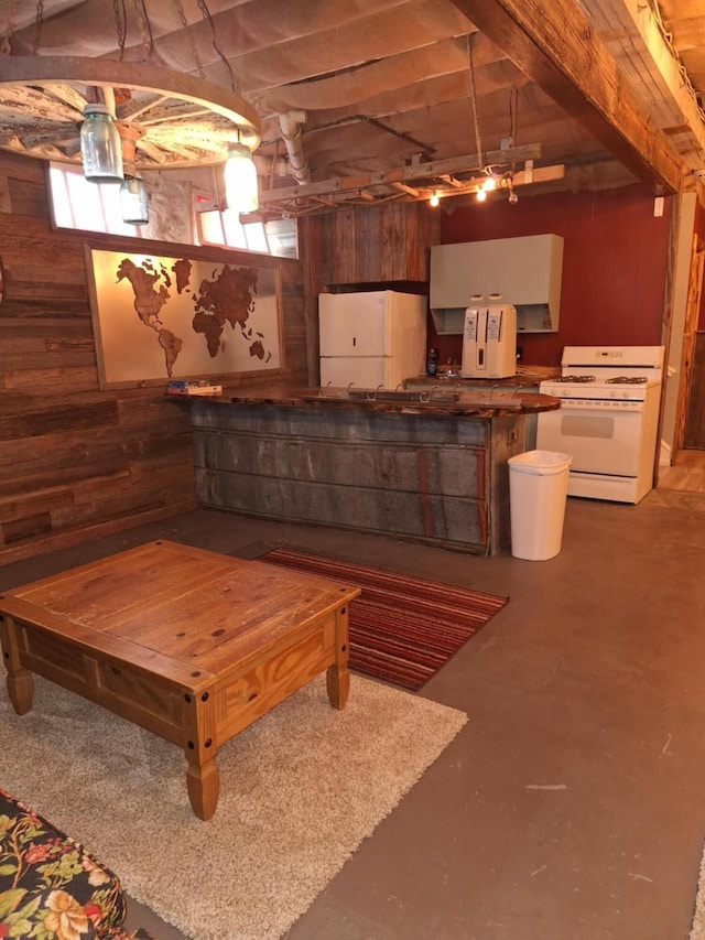 624 N Main St, Evart, MI 49631 - below grade area featuring freestanding refrigerator and wood walls