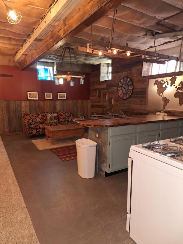 624 N Main St, Evart, MI 49631 - bar area featuring wooden walls, white range with gas stovetop, concrete flooring, and beamed ceiling