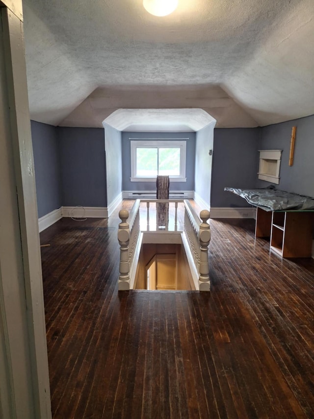 624 N Main St, Evart, MI 49631 - bonus room featuring vaulted ceiling, a textured ceiling, and hardwood / wood-style flooring
