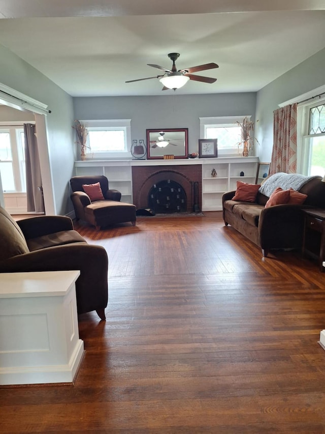 624 N Main St, Evart, MI 49631 - living room with plenty of natural light, ceiling fan, dark wood-type flooring, and a fireplace with flush hearth